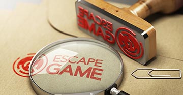 vergrootglas met daarin de tekst Escape Game